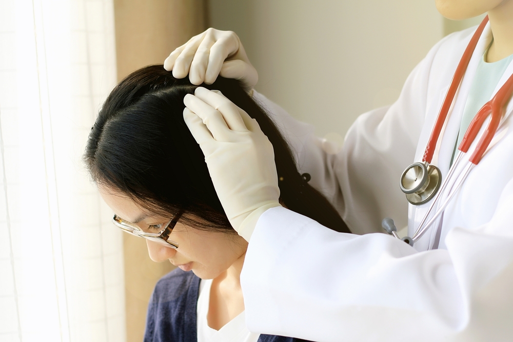 Female,Doctor,Looking,At,Patient’s,Hair,And,Scalp,,Dermatologist,Exam